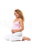 Pregnant woman is caressing her belly