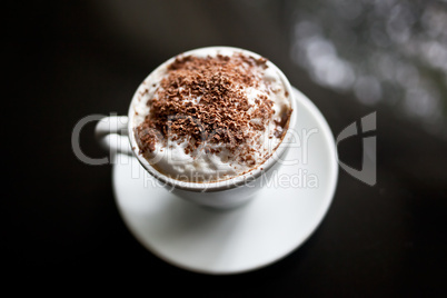 Cappuccino in white cup with chocolate sprinkles