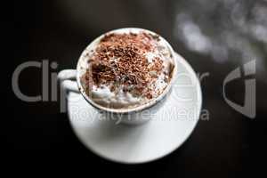 Cappuccino in white cup with chocolate sprinkles