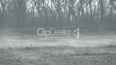 steam rises above the plowed field