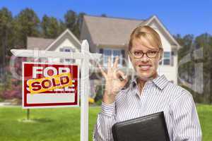 Real Estate Agent in Front of Sold Sign and House