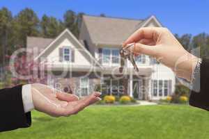 Agent Handing Over the House Keys in Front of New Home