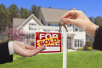 Agent Handing Over the House Keys in Front of New Home