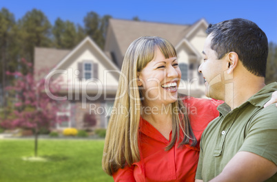 Happy Mixed Race Couple in Front of House