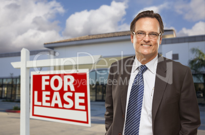 Businessman In Front of Office Building and For Lease Sign