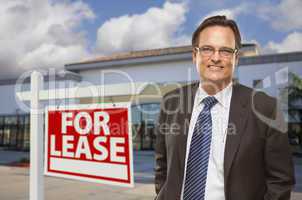 Businessman In Front of Office Building and For Lease Sign