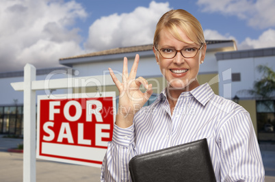 Businesswoman In Front of Office Building and For Sale Sign