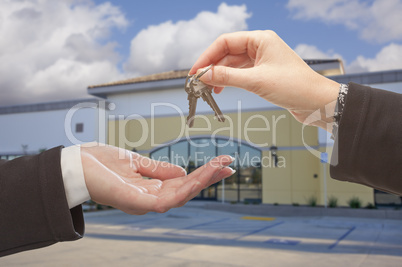 Agent Handing Over the Keys in Front of Business Office