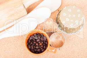 Cup of coffee bean and bakery equipment on table