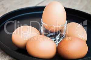 Many eggs in a black tray