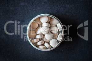 Natural vitamin pills in package on dark background