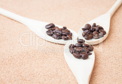 Roast coffee bean in wood spoons