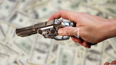 Loading Gun over Cash Background