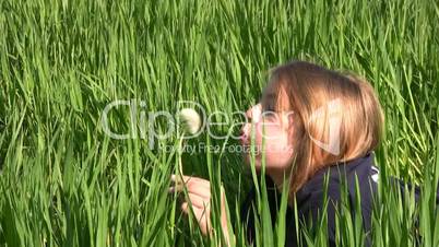 Girl, dandelion and grass
