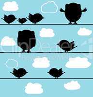 Silhouette of birds owl on a wire with clouds