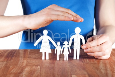 hand protecting a family