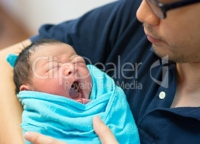 Asian father and newborn baby