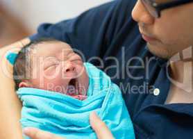 Asian father and newborn baby