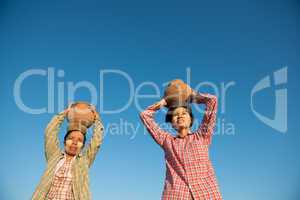 Asian traditional farmers carrying pot on head