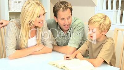Little Boy and his Parents Reading a Book