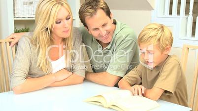 Proud Parents Listening to Their Son Reading