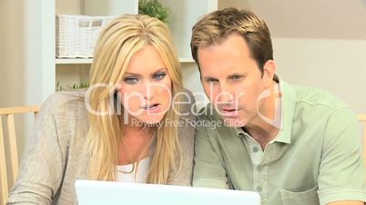 Modern Young Couple Using Home Laptop for Shopping