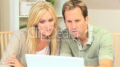Blonde Couple Pleased with Laptop Online Success
