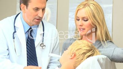 Young Caucasian Boy with Doctor at Hospital Clinic