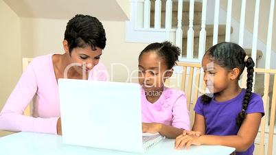 Cute Little African American Girls Playing on Laptop