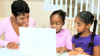 Cute Little African American Girls Playing on Laptop