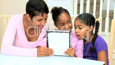 Cute Little African American Girls Playing Modern Tablet