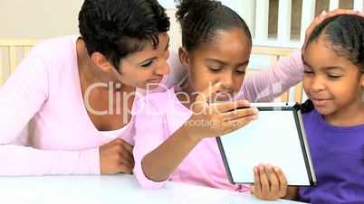 African American Mother and Daughters with Wireless Tablet