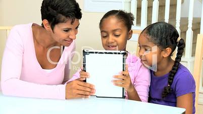 African American Mother and Daughters with Wireless Tablet