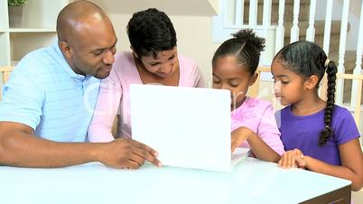 Little Ethnic Girls Using Laptop Computer with Parents