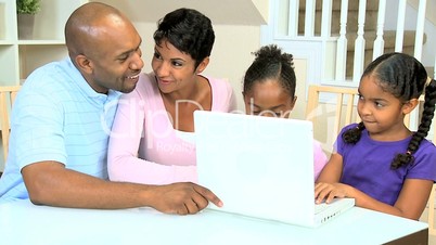 Ethnic Parents Watching Daughters Using Laptop