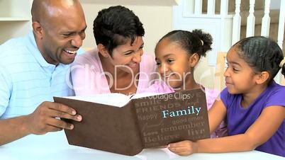 Young Ethnic Family Enjoying Photograph Album