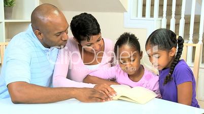 Little African American Girl Reading with her Family