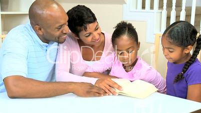 Little Ethnic Girl Reading with Family