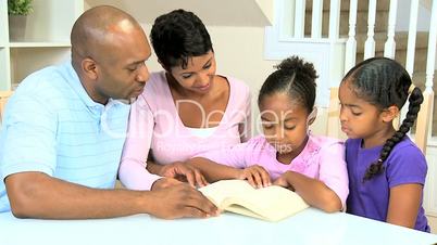 Little Ethnic Girl Reading to Family