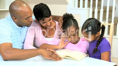 Little Ethnic Girl Reading with Family
