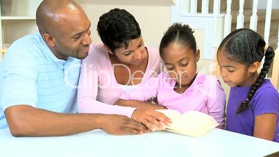 Little Ethnic Girl Reading to Family