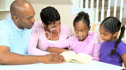 Young Ethnic Child Reading Aloud to Family