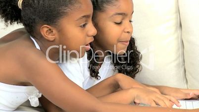 Little Ethnic Girls Playing on Laptop