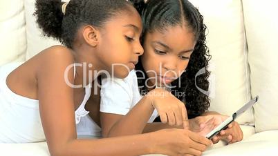 Little Ethnic Girls with Wireless Tablet