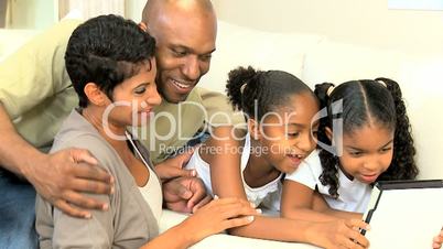 Young Ethnic Family Using Wireless Tablet