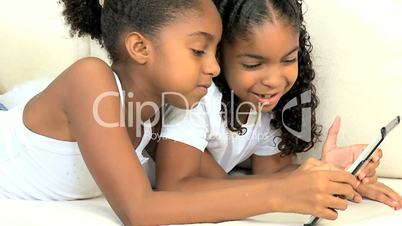 Little Ethnic Girls with Wireless Tablet