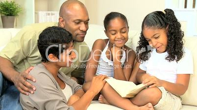 Little Ethnic Girl Reading to Family