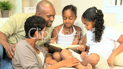 Young Ethnic Child Reading Aloud to Family