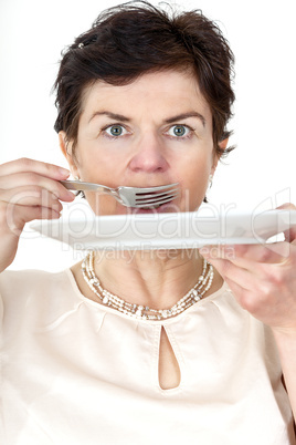 Woman with plate and fork in hand