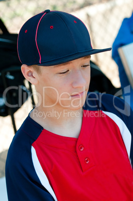 Teen Baseball boy in dugout
